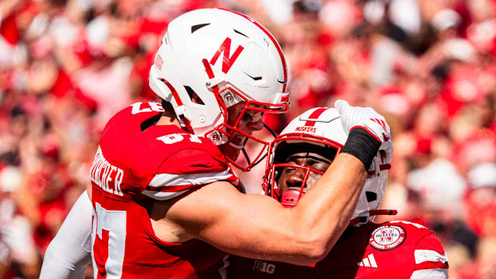 Aug 31, 2024; Lincoln, Nebraska, USA; Nebraska Cornhuskers tight end Nate Boerkircher (87) celebrates with running back Emmett Johnson (21) after a run against the UTEP Miners during the second quarter at Memorial Stadium. Mandatory Credit: Dylan Widger-Imagn Images