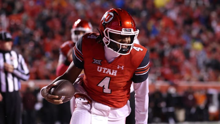 Utah Utes quarterback Devon Dampier (4) scores a touchdown during a game at Rice-Eccles Stadium.