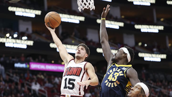 Nov 20, 2024; Houston, Texas, USA; Houston Rockets guard Reed Sheppard (15) shoots the ball as Indiana Pacers forward Pascal Siakam (43) defends during the second quarter at Toyota Center. Mandatory Credit: Troy Taormina-Imagn Images