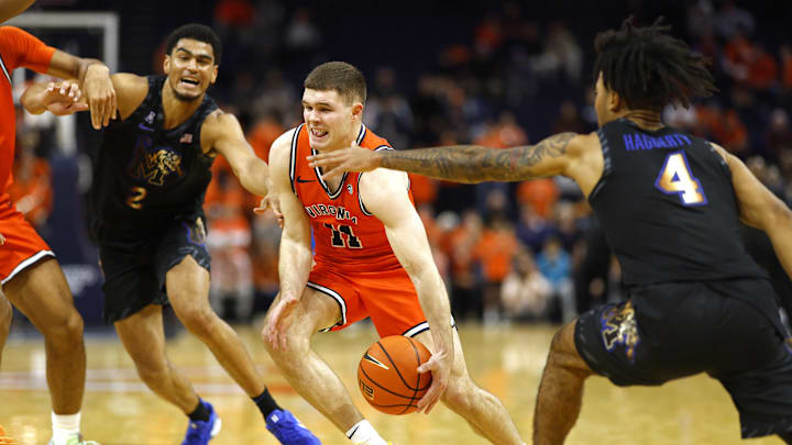 Dec 18, 2024; Charlottesville, Virginia, USA; Virginia Cavaliers guard Isaac McKneely (11) drives to the basket as Memphis Tigers forward Christopher Mantis (2) and Tigers guard Caleb Crawford (4) defend in the second half at John Paul Jones Arena. Mandatory Credit: Geoff Burke-Imagn Images