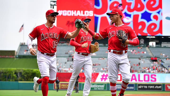 Aug 19, 2023; Anaheim, California, USA; Los Angeles Angels left fielder Randal Grichuk (15) is greeted by shortstop Andrew Velazquez (4) after catching the fly ball of Tampa Bay Rays designated hitter Yandy Diaz (2) to end the top of the second inning at Angel Stadium. Mandatory Credit: Gary A. Vasquez-Imagn Images