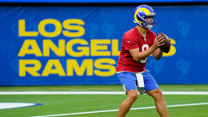 Jun 10, 2021; Los Angeles, CA, USA; Los Angeles Rams quarterback Matthew Stafford (9) drops back in a passing drill during an offseason workout at SoFi Stadium. Mandatory Credit: Robert Hanashiro-Imagn Images