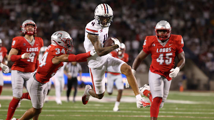 Wide receiver Tetairoa McMillan #4 of the Arizona Wildcats runs past safety Noa Pola-Gates #34 of the New Mexico Lobos during the second half at Arizona Stadium on August 31, 2024 in Tucson, Arizona. McMillan has set the program single game receiving record.