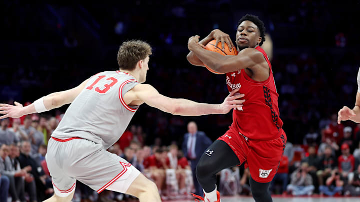 Feb 17, 2026; Columbus, Ohio, USA; Wisconsin Badgers guard John Blackwell (25) protects the ball as Ohio State Buckeyes center Christoph Tilly (13) defends during the first half at Value City Arena. Mandatory Credit: Joseph Maiorana-Imagn Images