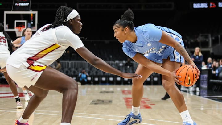 Oct 30, 2025; Atlanta, GA, USA; North Carolina Tar Heels forward Nyla Harris (2) protects the ball against South Carolina Gamecocks center Madina Okot (11) during the first quarter at State Farm Arena. Mandatory Credit: Jordan Godfree-Imagn Images