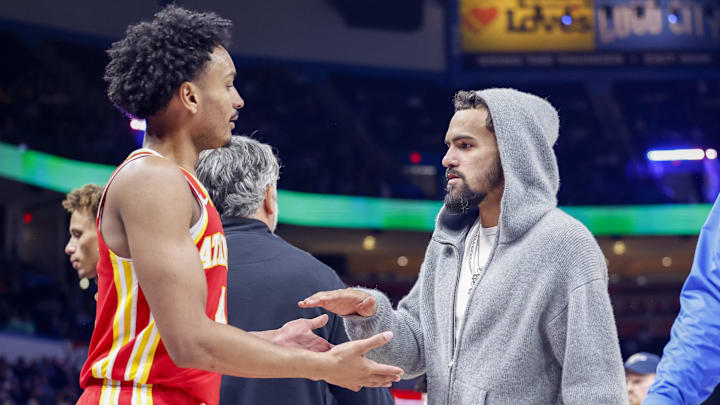 Oct 17, 2024; Oklahoma City, Oklahoma, USA; Atlanta Hawks guard Kobe Bufkin (4) and guard Trae Young (11)  high five during a time out against the Oklahoma City Thunder during the second half at Paycom Center. Mandatory Credit: Alonzo Adams-Imagn Images