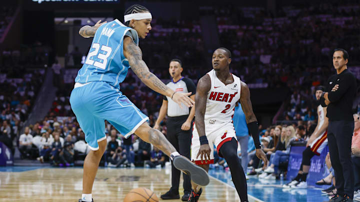 Oct 26, 2024; Charlotte, North Carolina, USA; Miami Heat guard Terry Rozier (2) passes the ball against Charlotte Hornets guard Tre Mann (23) during the first quarter at Spectrum Center. Mandatory Credit: Nell Redmond-Imagn Images