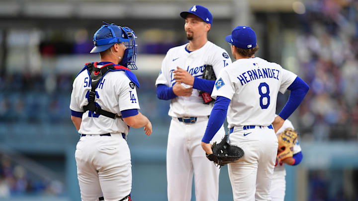 Apr 2, 2025; Los Angeles, California, USA; Los Angeles Dodgers pitcher Blake Snell (7) is visited by catcher Will Smith (16) and third baseman Enrique Hernandez (8) during the second inning against the Atlanta Braves at Dodger Stadium. Mandatory Credit: Gary A. Vasquez-Imagn Images