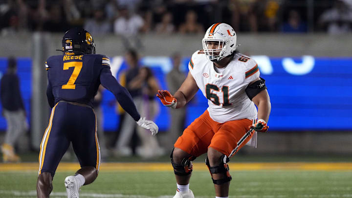 Oct 5, 2024; Berkeley, California, USA; Miami Hurricanes offensive lineman Francis Mauigoa (61) blocks against California Golden Bears linebacker David Reese (7) during the first quarter at California Memorial Stadium. Mandatory Credit: Darren Yamashita-Imagn Images