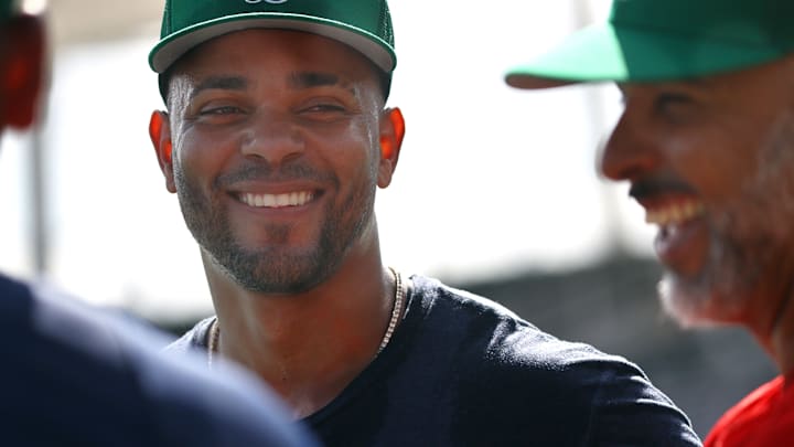 Former Boston Red Sox shortstop Xander Bogaerts talks with manager Alex Cora.