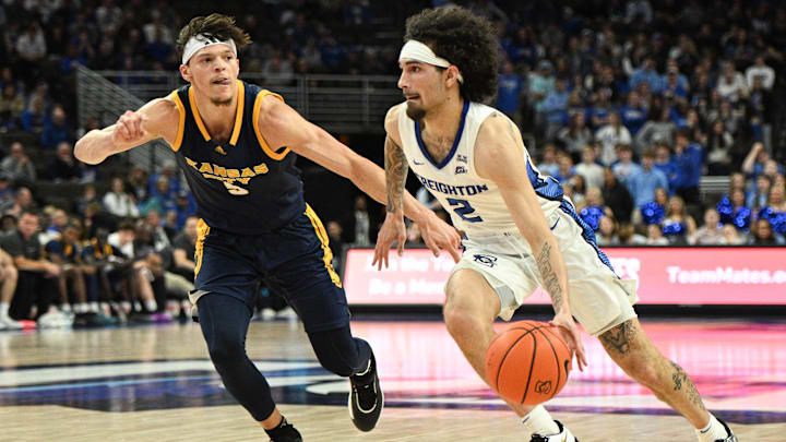 Nov 16, 2024; Omaha, Nebraska, USA;  Creighton Bluejays guard Pop Isaacs (2) drives against UMKC Kangaroos guard Jamar Brown (5) in the second half at CHI Health Center Omaha. Mandatory Credit: Steven Branscombe-Imagn Images