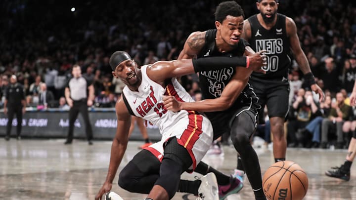 Jan 15, 2024; Brooklyn, New York, USA;  Miami Heat center Bam Adebayo (13) and Brooklyn Nets center Nic Claxton (33) fight for a loose ball in the fourth quarter at Barclays Center. Mandatory Credit: Wendell Cruz-Imagn Images