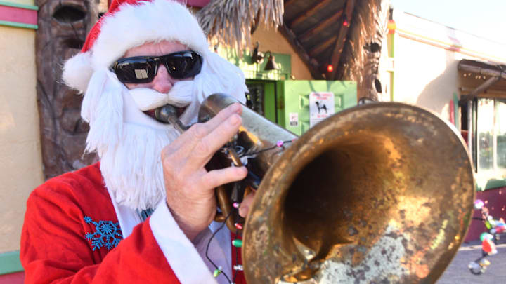 The Surfing Santas of Cocoa Beach had the biggest crowd ever Christmas Eve morning, Dec. 24., estimated well over 10,000. There were hundreds of Surfing Santas, even a Santa and elf surfing in a sleigh.The costume party had dueling Barbies, Christmas trees, Smurfs, Cousin Eddie with Santa Claus winning the prize.