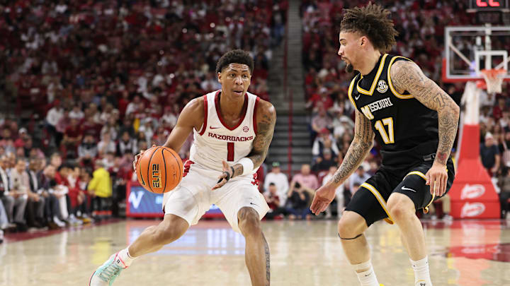 Feb 21, 2026; Fayetteville, Arkansas, USA; Arkansas Razorbacks guard Meleek Thomas (1) drives against Missouri Tigers guard Jayden Stone (17) during the first half at Bud Walton Arena. Mandatory Credit: Nelson Chenault-Imagn Images