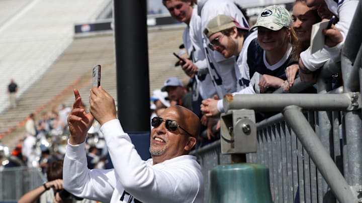 Penn State football coach James Franklin takes a selfie with students following the Blue-White Game at Beaver Stadium. 