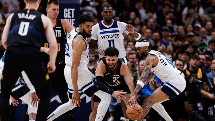 May 6, 2024; Denver, Colorado, USA; Minnesota Timberwolves guard Nickeil Alexander-Walker (9) strips the ball from Denver Nuggets guard Jamal Murray (27) as center Karl-Anthony Towns (32) and center Naz Reid (11) defend in the second quarter during game two of the second round for the 2024 NBA playoffs at Ball Arena. Mandatory Credit: Isaiah J. Downing-Imagn Images