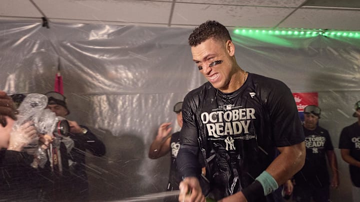New York Yankees designated hitter Aaron Judge and other players celebrate clinching a playoff spot after the win over the Seattle Mariners at T-Mobile Park on Sept 18.