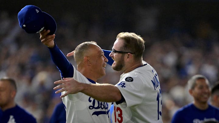 Oct 9, 2025; Los Angeles, California, USA; Los Angeles Dodgers manager Dave Roberts (30) and Los Angeles Dodgers third baseman Max Muncy (13) celebrate after defeating the Philadelphia Phillies in game four of the NLDS round for the 2025 MLB playoffs at Dodger Stadium. Mandatory Credit: Jayne Kamin-Oncea-Imagn Images