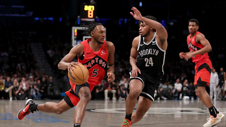 Apr 10, 2024; Brooklyn, New York, USA; Toronto Raptors guard Immanuel Quickley (5) drives to the basket against Brooklyn Nets guard Cam Thomas (24) during the fourth quarter at Barclays Center. Mandatory Credit: Brad Penner-Imagn Images