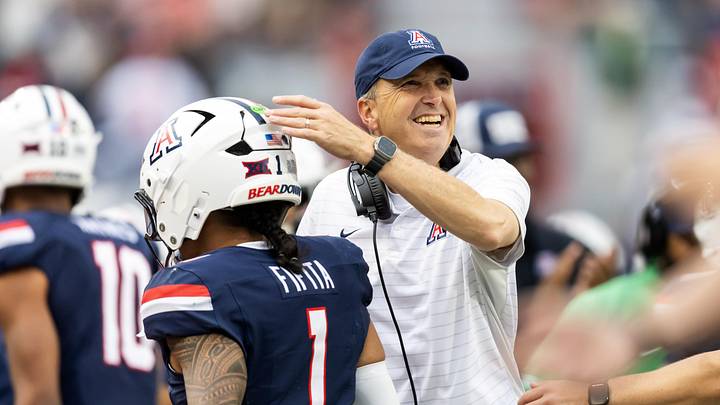 Nov 22, 2025; Tucson, Arizona, USA; Arizona Wildcats head coach Brent Brennan celebrates with quarterback Noah Fifita (1) against the Baylor Bears at Casino Del Sol Stadium. Mandatory Credit: Mark J. Rebilas-Imagn Images