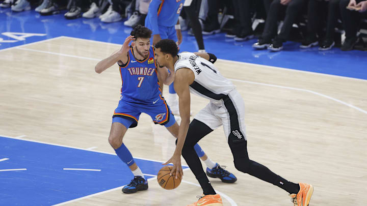 Jan 13, 2026; Oklahoma City, Oklahoma, USA; San Antonio Spurs forward/center Victor Wembanyama (1) drives to the basket past Oklahoma City Thunder center/forward Chet Holmgren (7) during the first quarter at Paycom Center. Mandatory Credit: Alonzo Adams-Imagn Images Jan 13, 2026; Oklahoma City, Oklahoma, USA; San Antonio Spurs forward/center Victor Wembanyama (1) drives to the basket past Oklahoma City Thunder center/forward Chet Holmgren (7) during the first quarter at Paycom Center. Mandatory Credit: Alonzo Adams-Imagn Images