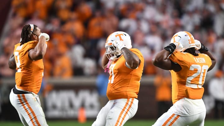 From left, Tennessee defensive linemen Tyler Baron (9), Omari Thomas (21), and Bryson Eason (20)