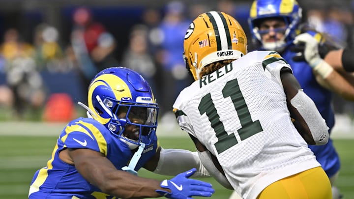 Oct 6, 2024; Inglewood, California, USA; Los Angeles Rams cornerback Josh Wallace (30) tackles Green Bay Packers wide receiver Jayden Reed (11) on a second qiuaarter pass pay at SoFi Stadium. Mandatory Credit: Robert Hanashiro-Imagn Images