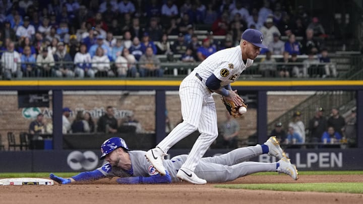 May 4, 2025; Milwaukee, Wisconsin, USA; Milwaukee Brewers second base Brice Turang (2) bobbles the ball as Chicago Cubs outfielder Kyle Tucker (30) slides safely into second base in the ninth inning at American Family Field. Mandatory Credit: Michael McLoone-Imagn Images