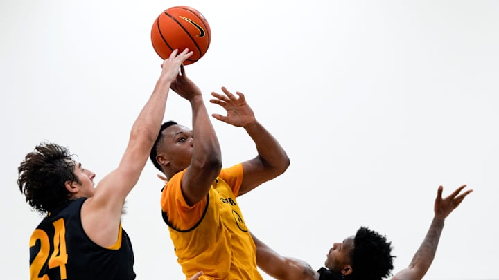 Iowa’s Cam Manyawu (4) drives to the basket as Tate Sage (24) and Tavion Banks (6) defend during practice June 19, 2025 at Carver-Hawkeye Arena in Iowa City, Iowa.