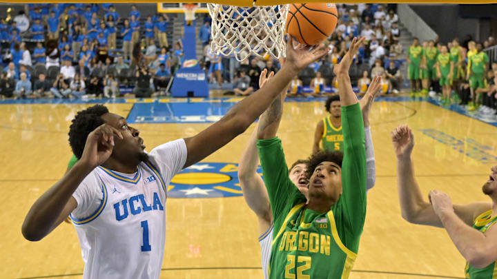 Dec 6, 2025; Los Angeles, California, USA;  UCLA Bruins forward Xavier Booker (1) and Oregon Ducks forward Devon Pryor (22) reach for a rebound during the first half at Pauley Pavilion presented by Wescom Financial. Mandatory Credit: Jayne Kamin-Oncea-Imagn Images