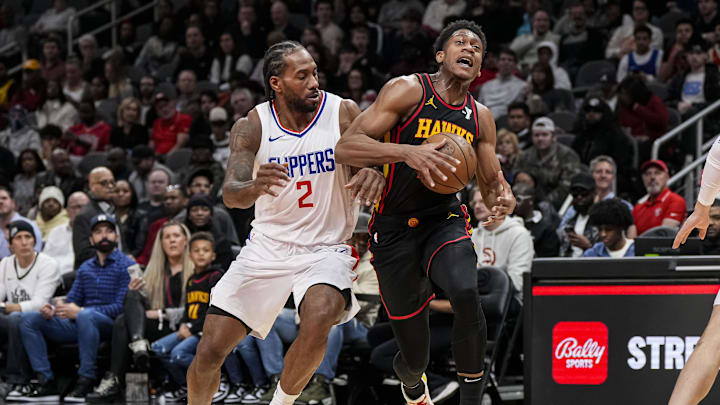 Feb 5, 2024; Atlanta, Georgia, USA; Atlanta Hawks forward De'Andre Hunter (12) tries to get past LA Clippers forward Kawhi Leonard (2) during the first half at State Farm Arena. Mandatory Credit: Dale Zanine-Imagn Images