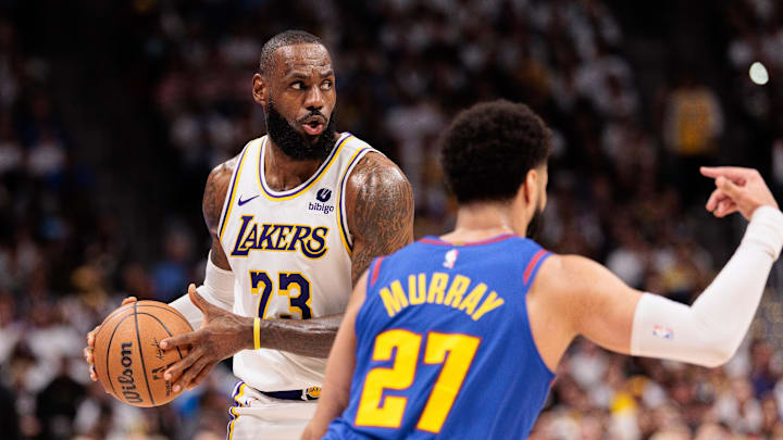 Apr 20, 2024; Denver, Colorado, USA; Los Angeles Lakers forward LeBron James (23) looks to pass during the third quarter against Denver Nuggets guard Jamal Murray (27) in game one of the first round for the 2024 NBA playoffs at Ball Arena. Mandatory Credit: Andrew Wevers-Imagn Images