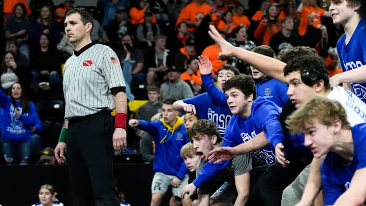 Don Bosco’s team reacts during a 165-pound match at the IHSAA State Dual Tournament Saturday, Feb. 8, 2025 at Xtream Arena in Coralville, Iowa.