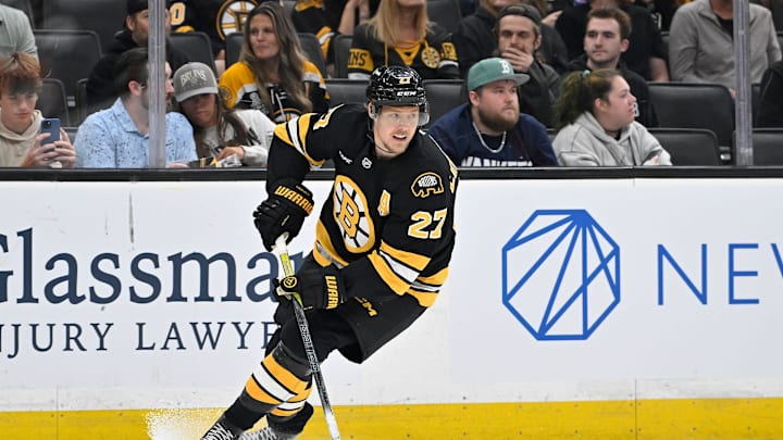 Sep 29, 2025; Boston, Massachusetts, USA;  Boston Bruins defenseman Hampus Lindholm (27) with the puck during the second period against the Philadelphia Flyers at TD Garden. Mandatory Credit: Eric Canha-Imagn Images