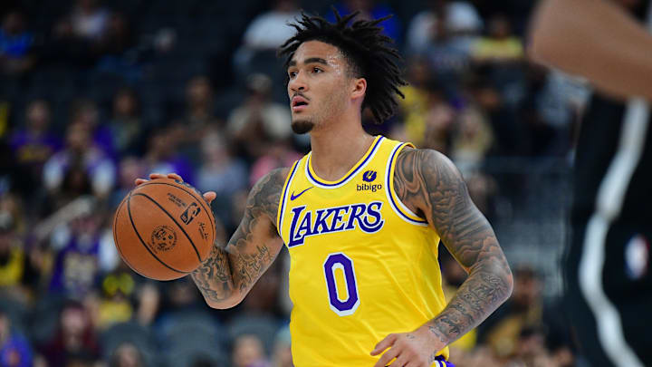 Oct 9, 2023; Las Vegas, Nevada, USA; Los Angeles Lakers guard Jalen Hood-Schifino (0) moves the ball against the Brooklyn Nets during the second half at T-Mobile Arena. Mandatory Credit: Gary A. Vasquez-Imagn Images