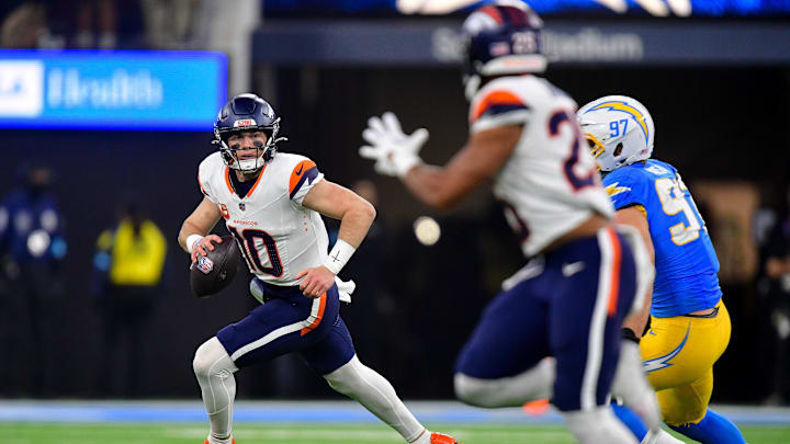 Dec 19, 2024; Inglewood, California, USA; Denver Broncos quarterback Bo Nix (10) runs out to pass as Los Angeles Chargers linebacker Joey Bosa (97) moves in during the second half at SoFi Stadium. 