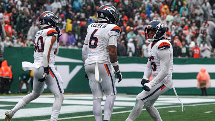 Sep 29, 2024; East Rutherford, New Jersey, USA; Denver Broncos safety P.J. Locke (6) celebrates a fourth quarter, fourth down defensive stop with linebacker Justin Strnad (40) and linebacker Nik Bonitto (15) during the second half against the New York Jets at MetLife Stadium. 