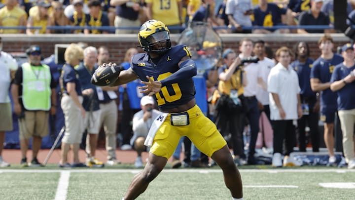 Sep 14, 2024; Ann Arbor, Michigan, USA;  Michigan Wolverines quarterback Alex Orji (10) throws against the Arkansas State Red Wolves during the second half at Michigan Stadium. Mandatory Credit: Rick Osentoski-Imagn Images