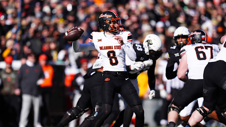 Nov 29, 2024; Boulder, Colorado, USA; Oklahoma State Cowboys quarterback Maealiuaki Smith (8 prepares to pass the ball in the second quarter against the Colorado Buffaloes at Folsom Field. Mandatory Credit: Ron Chenoy-Imagn Images