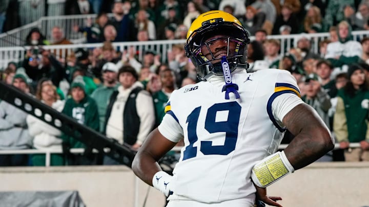 East Lansing, Michigan, USA; Michigan Wolverines quarterback Bryce Underwood (19) reacts after scoring a touchdown against the Michigan State Spartans during the first half at Spartan Stadium.
