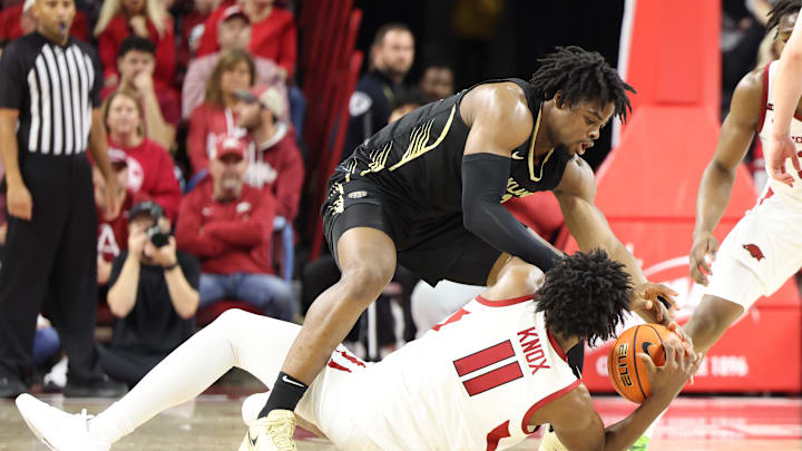 Dec 30, 2024; Fayetteville, Arkansas, USA; Arkansas Razorbacks forward Karter Knox (11) and Oakland Golden Grizzlies forward Allen Mukeba (23) reach for a loose ball in the first half at Bud Walton Arena. Mandatory Credit: Nelson Chenault-Imagn Images