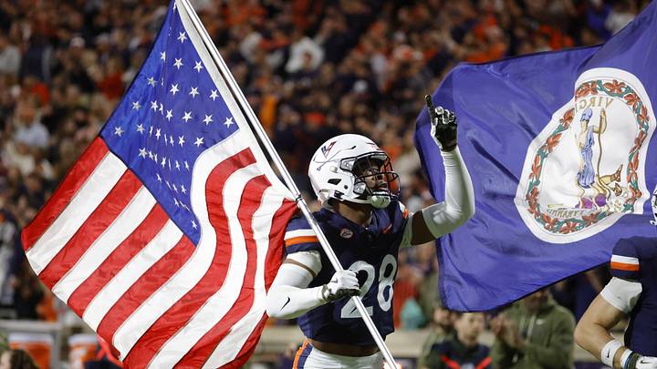 Nov 8, 2025; Charlottesville, Virginia, USA; Virginia Cavaliers defensive back Donavon Platt (28) carries the flag onto the field prior to the game against the Wake Forest Demon Deacons at Scott Stadium. Mandatory Credit: Amber Searls-Imagn Images Nov 8, 2025; Charlottesville, Virginia, USA; Virginia Cavaliers defensive back Donavon Platt (28) carries the flag onto the field prior to the game against the Wake Forest Demon Deacons at Scott Stadium. Mandatory Credit: Amber Searls-Imagn Images