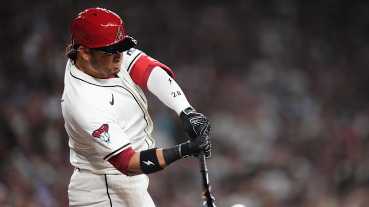 Arizona Diamondbacks Eugenio Suarez (28) hits a single during their Opening Day game against the Chicago Cubs at Chase Field in Phoenix on March 27, 2025.