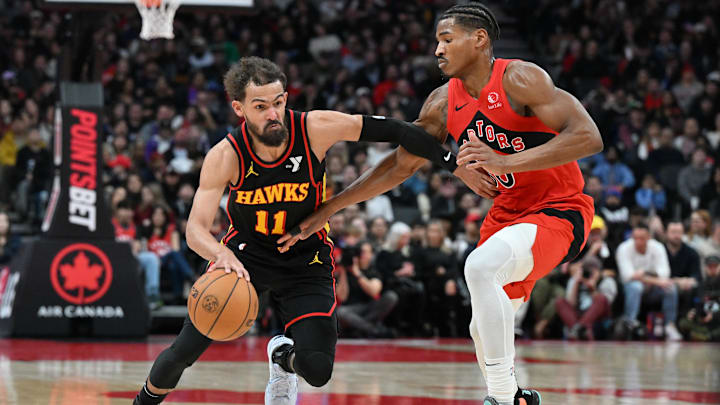 Dec 29, 2024; Toronto, Ontario, CAN; Atlanta Hawks guard Trae Young (11) dribbles the ball past Toronto Raptors guard Ochai Agbaji (30) in the first half at Scotiabank Arena. Mandatory Credit: Dan Hamilton-Imagn Images Dec 29, 2024; Toronto, Ontario, CAN; Atlanta Hawks guard Trae Young (11) dribbles the ball past Toronto Raptors guard Ochai Agbaji (30) in the first half at Scotiabank Arena. Mandatory Credit: Dan Hamilton-Imagn Images