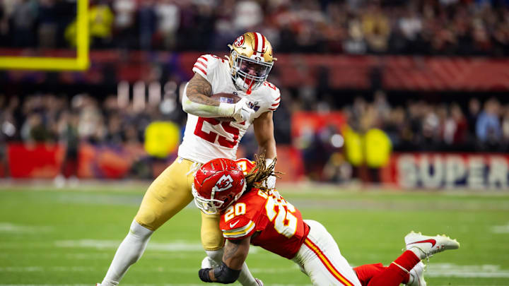 Feb 11, 2024; Paradise, Nevada, USA; San Francisco 49ers running back Elijah Mitchell (25) is tackled by Kansas City Chiefs safety Justin Reid (20) in Super Bowl LVIII at Allegiant Stadium. Mandatory Credit: Mark J. Rebilas-Imagn Images