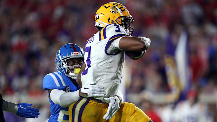 Sep 30, 2023; Oxford, Mississippi, USA; LSU Tigers running back Logan Diggs (3) runs the ball for a touchdown as Mississippi Rebels defensive back Trey Washington (25) attempts to make the tackle during the second half at Vaught-Hemingway Stadium. Mandatory Credit: Petre Thomas-Imagn Images Sep 30, 2023; Oxford, Mississippi, USA; LSU Tigers running back Logan Diggs (3) runs the ball for a touchdown as Mississippi Rebels defensive back Trey Washington (25) attempts to make the tackle during the second half at Vaught-Hemingway Stadium. Mandatory Credit: Petre Thomas-Imagn Images