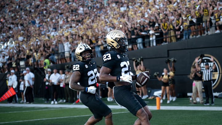 Vanderbilt running back Makhilyn Young (22) and running back AJ Newberry (23) celebrate Newberry's touchdown against Charleston Southern during their game at FirstBank Stadium in Nashville, Tenn., Saturday, Aug. 30, 2025.

The nearly perfect symmetry, mimicry of the two running backs in this image grabbed my attention immediately. We do a lot of pictures of athletes celebrating scores, but this one had a little something extra that most of my pictures don’t.