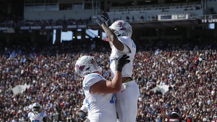 Nov 28, 2025; Starkville, Mississippi, USA; Mississippi Rebels offensive lineman Patrick Kutas (75) and wide receiver Harrison Wallace III (2) celebrate after a touchdown in the first half against the Mississippi State Bulldogs at Davis Wade Stadium at Scott Field. Mandatory Credit: Petre Thomas-Imagn Images