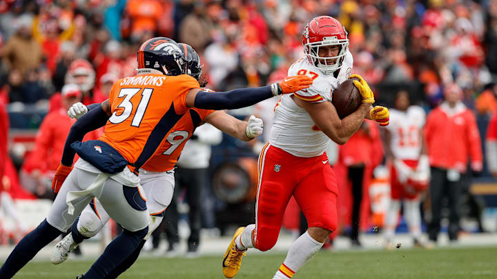 Oct 29, 2023; Denver, Colorado, USA; Kansas City Chiefs tight end Travis Kelce (87) runs the ball against Denver Broncos safety Justin Simmons (31) and linebacker Alex Singleton (49) in the second quarter at Empower Field at Mile High. Mandatory Credit: Isaiah J. Downing-Imagn Images