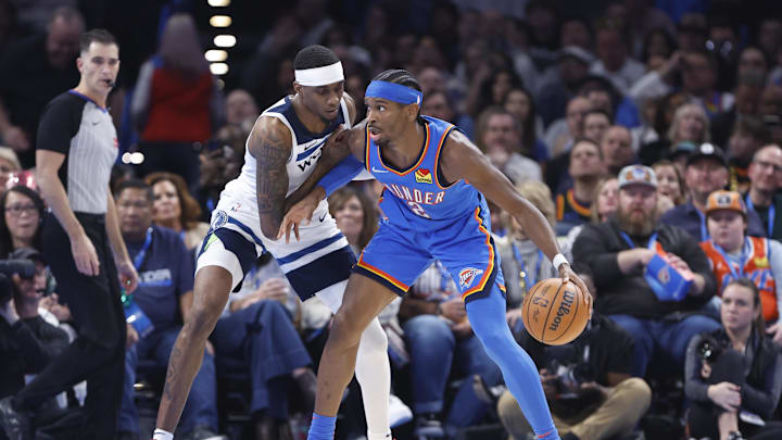 Minnesota Timberwolves forward Jaden McDaniels (3) defends a drive by Oklahoma City Thunder guard Shai Gilgeous-Alexander (2) during the second quarter at Paycom Center on Dec. 31.